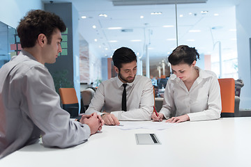 Image showing young couple signing contract documents on partners back