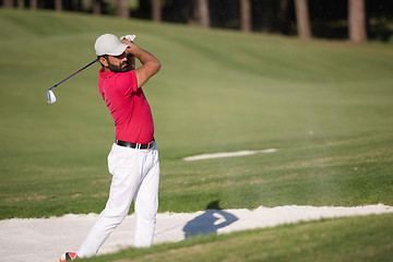 Image showing golfer hitting a sand bunker shot