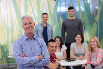 Image showing portrait of  teacher with students group in background