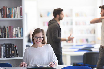 Image showing female student study in school library, group of students in bac