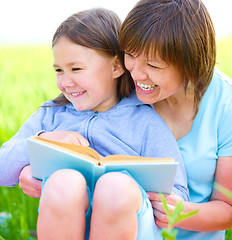 Image showing Mother is reading book with her daughter