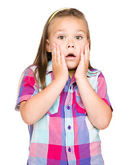 Image showing Little girl is holding her face in astonishment