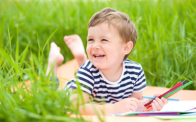 Image showing Little boy is playing with pencils