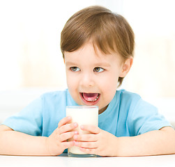 Image showing Cute little boy with a glass of milk