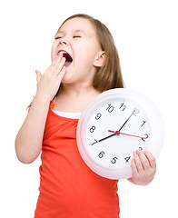 Image showing Little girl is holding big clock