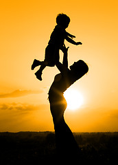 Image showing Silhouette of mother playing with her son