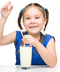 Image showing Cute little girl with a glass of milk