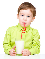 Image showing Cute little boy with a glass of milk