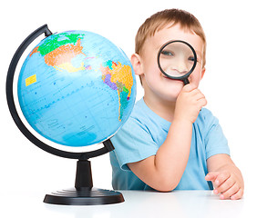 Image showing Happy little boy with a globe