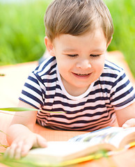 Image showing Little boy is reading book