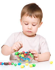 Image showing Portrait of a boy with candies