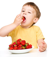 Image showing Happy little boy with strawberries