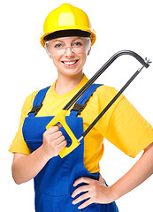 Image showing Young construction worker with hacksaw