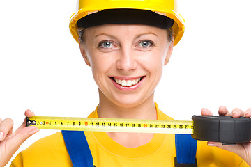 Image showing Young construction worker with tape measure