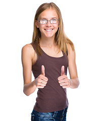 Image showing Woman is showing thumb up gesture