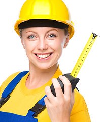 Image showing Young construction worker with tape measure