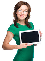 Image showing Young cheerful woman is showing blank tablet