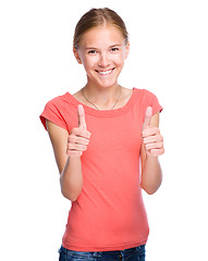 Image showing Young girl is showing thumb up gesture
