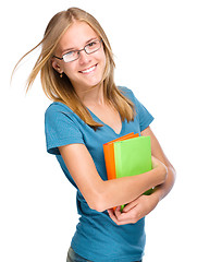 Image showing Young student girl is holding book