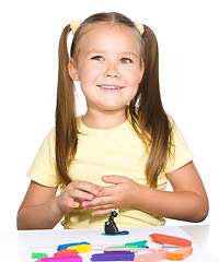 Image showing Little girl is playing with plasticine