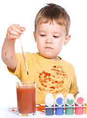 Image showing Little boy is playing with paints