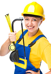 Image showing Young construction worker with hacksaw