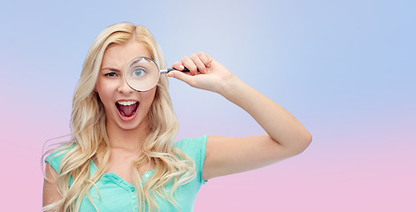 Image showing happy young woman with magnifying glass