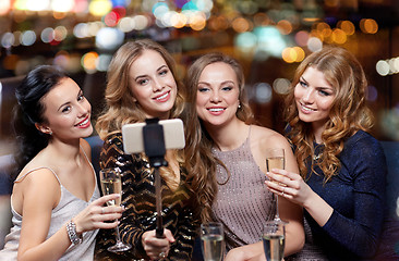 Image showing women with smartphone taking selfie at night club