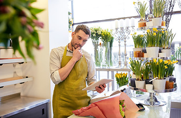 Image showing man with tablet pc computer at flower shop