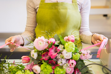 Image showing close up of woman making bunch at flower shop