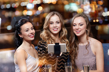 Image showing women with smartphone taking selfie at night club