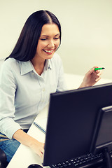 Image showing smiling businesswoman or student studying