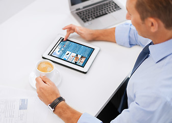 Image showing businessman with tablet pc and coffee in office
