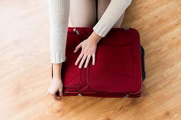 Image showing close up of woman packing travel bag for vacation