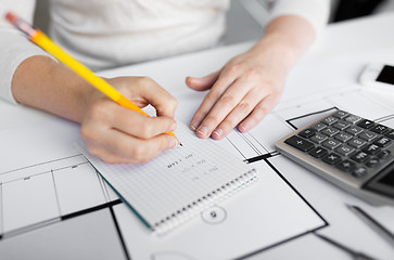 Image showing close up of architect hand writing to notebook