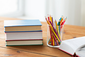 Image showing close up of crayons or color pencils and books