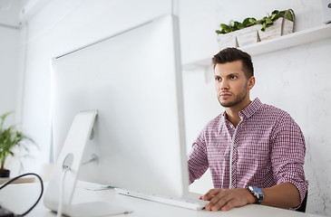 Image showing creative man or student with computer at office