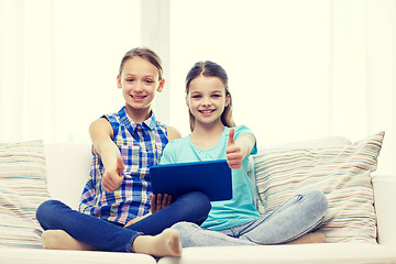 Image showing happy girls with tablet pc and showing thumbs up