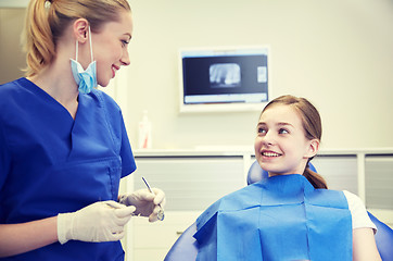 Image showing female dentist checking patient girl teeth