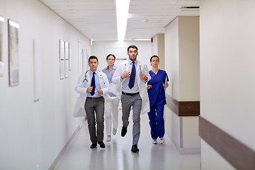 Image showing group of medics walking along hospital