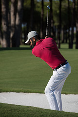 Image showing golfer hitting a sand bunker shot