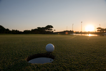 Image showing golf ball on edge of  the hole