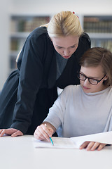 Image showing female teacher helping students on class