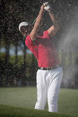 Image showing golfer hitting a sand bunker shot