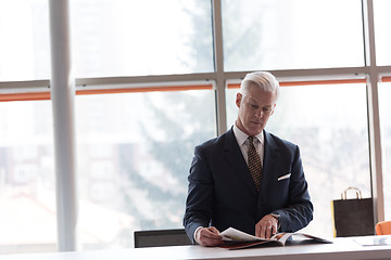 Image showing senior business man reading magazine