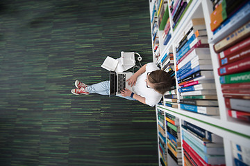 Image showing female student study in library, using tablet and searching for 