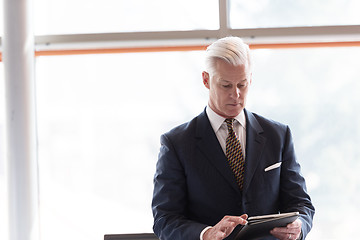 Image showing senior business man working on tablet computer