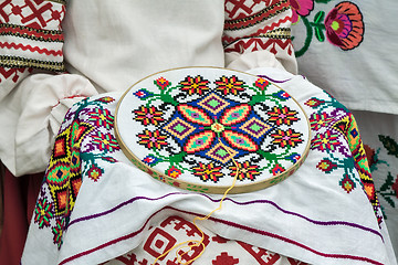 Image showing Crafts: beautiful embroidered tablecloth in the process of embro
