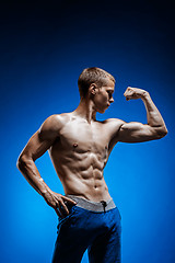 Image showing Fit young man with beautiful torso on blue background