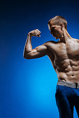 Image showing Fit young man with beautiful torso on blue background